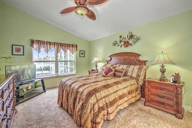 bedroom with carpet flooring, lofted ceiling, baseboards, and a ceiling fan