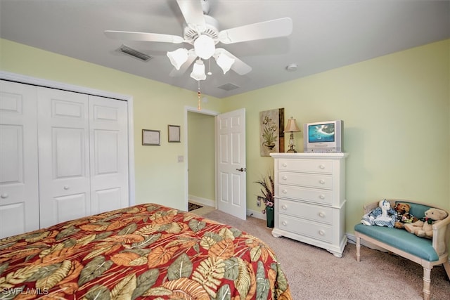 bedroom with a closet, light colored carpet, and ceiling fan