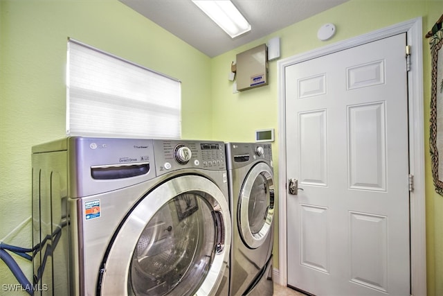 clothes washing area featuring washer and clothes dryer