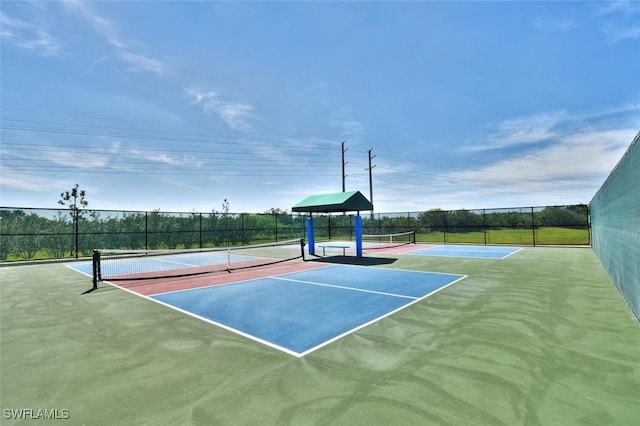 view of tennis court featuring fence