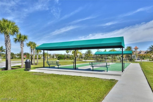 view of property's community featuring a game area and a lawn