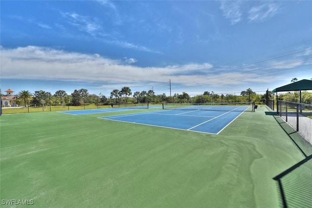 view of tennis court featuring fence