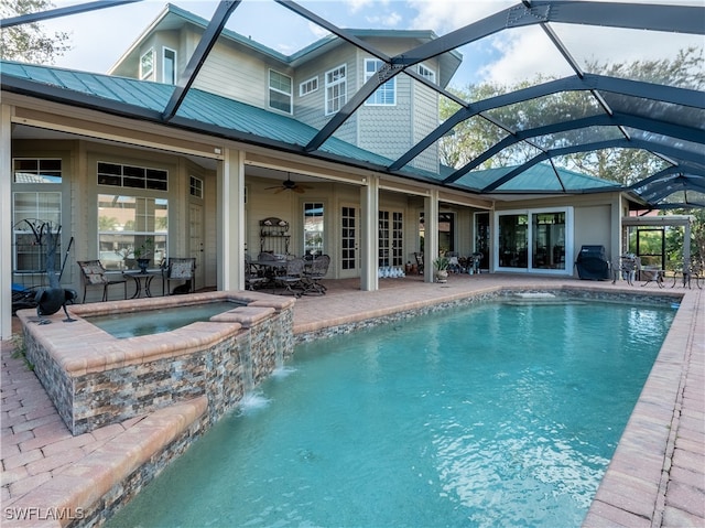 view of pool with an in ground hot tub, a patio area, ceiling fan, and a lanai