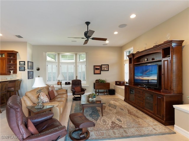 living room with plenty of natural light, ceiling fan, and light tile patterned floors