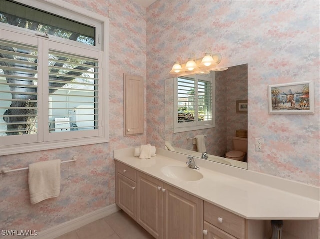 bathroom featuring tile patterned flooring, vanity, and toilet