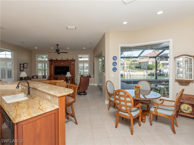 dining room featuring ceiling fan and sink