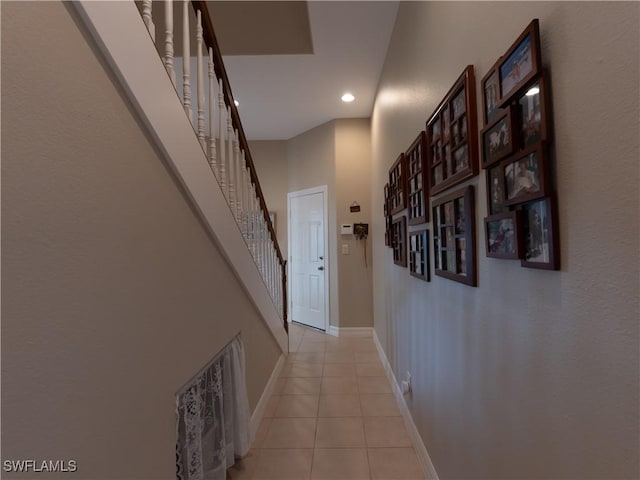 corridor with a high ceiling and light tile patterned flooring