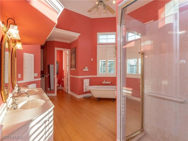 bathroom with hardwood / wood-style floors, vanity, ceiling fan, ornamental molding, and independent shower and bath