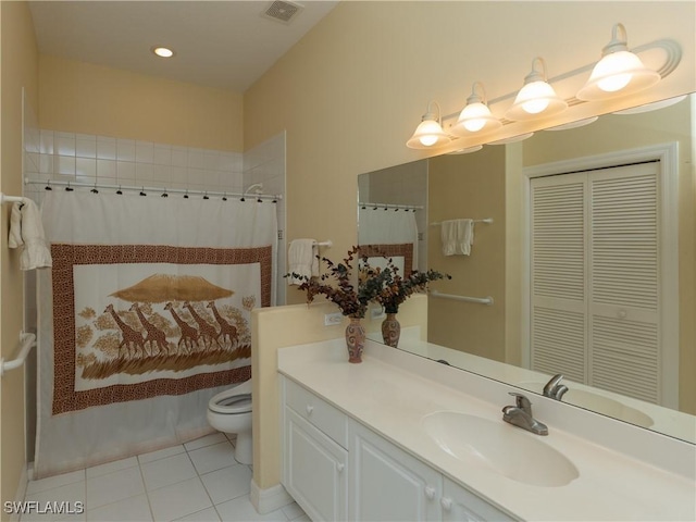 bathroom featuring tile patterned floors, vanity, a shower with shower curtain, and toilet