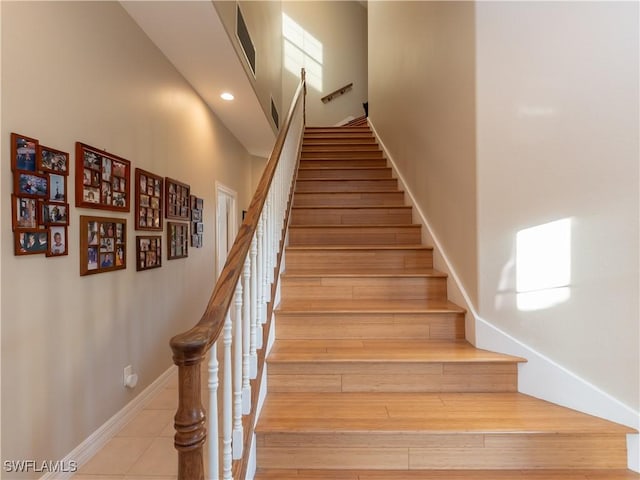 stairs featuring a high ceiling