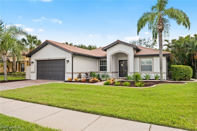 view of front of home featuring a front lawn and a garage