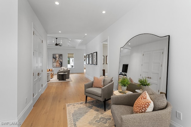 living room with light hardwood / wood-style floors and ceiling fan