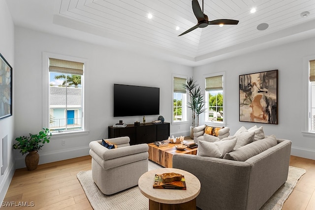 living room featuring light hardwood / wood-style flooring, a tray ceiling, ceiling fan, and wood ceiling