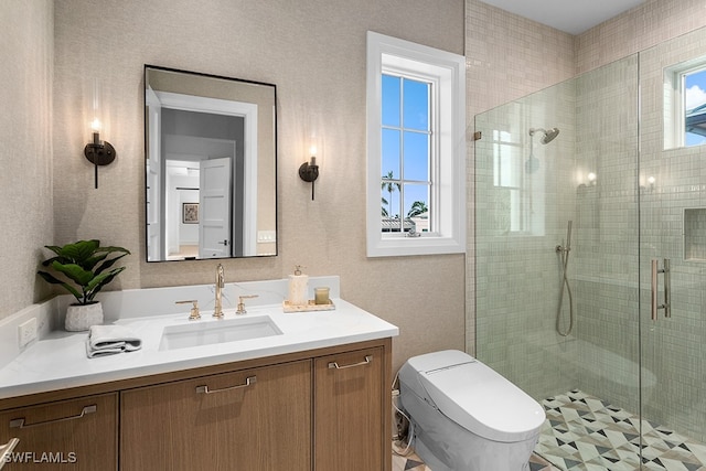 bathroom featuring an enclosed shower, a wealth of natural light, vanity, and toilet