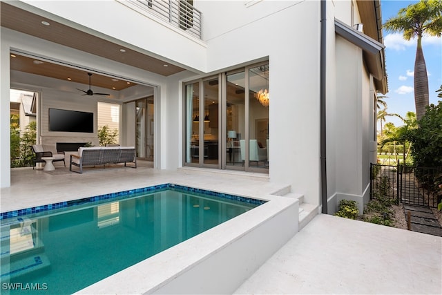 view of pool featuring a patio, an outdoor living space, and ceiling fan