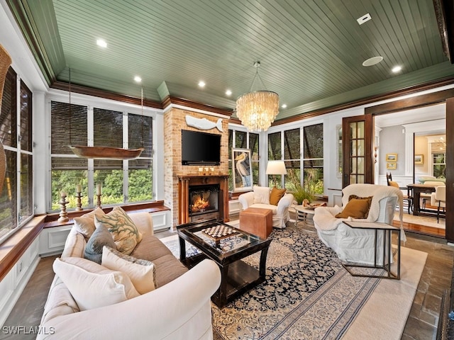 sunroom with wood ceiling, a fireplace, and a wealth of natural light