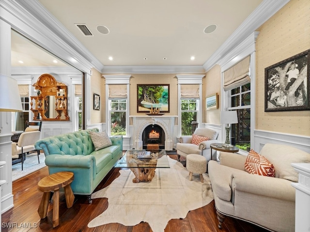 living room with hardwood / wood-style flooring and crown molding