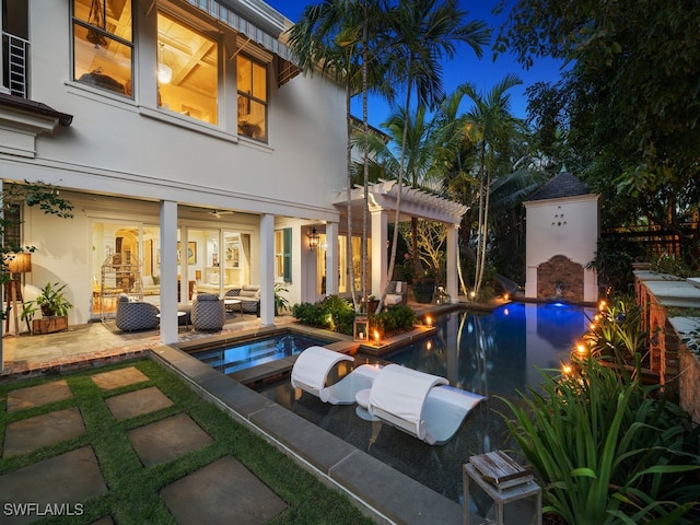 view of pool with an outdoor living space with a fireplace and a patio area