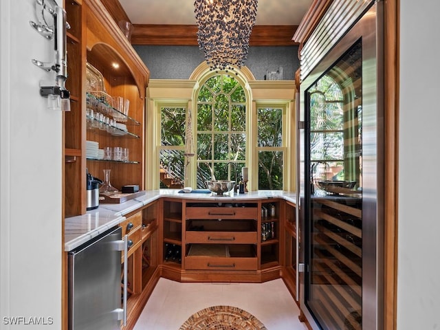 bar featuring stainless steel refrigerator, a wealth of natural light, a chandelier, and wine cooler