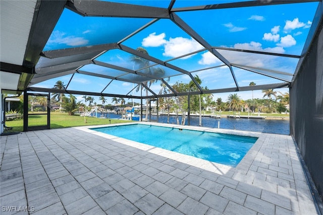 view of swimming pool featuring glass enclosure, a patio area, a water view, and a lawn