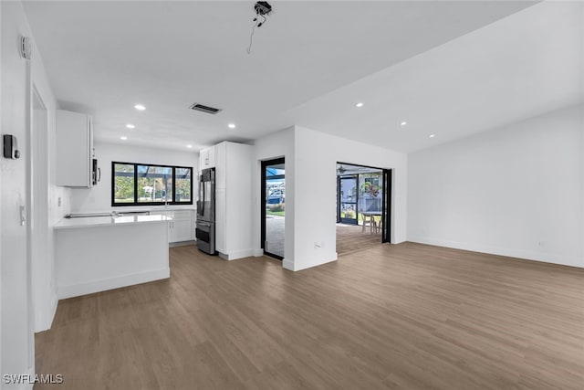 unfurnished living room featuring light wood-type flooring