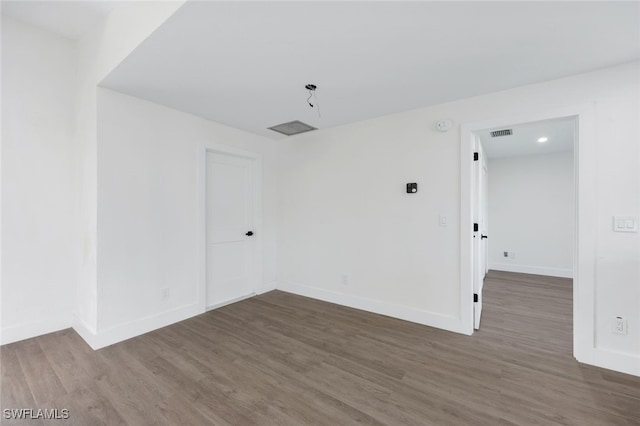 empty room with dark wood-type flooring