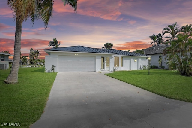 ranch-style house with a lawn and a garage