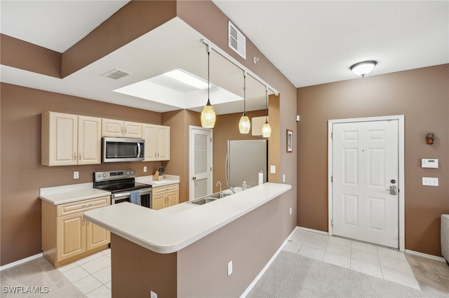 kitchen with sink, kitchen peninsula, decorative light fixtures, light carpet, and appliances with stainless steel finishes