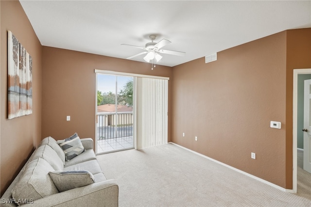 carpeted living room with ceiling fan