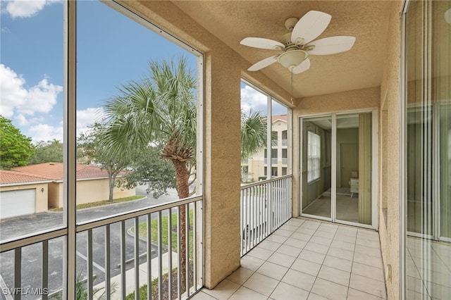 unfurnished sunroom featuring ceiling fan