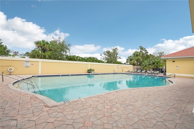 view of swimming pool with a patio