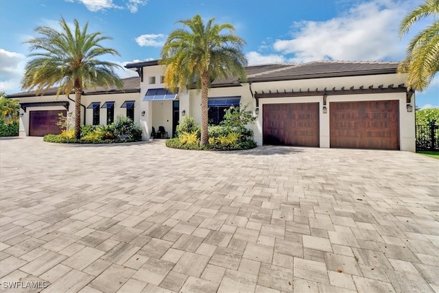 mediterranean / spanish home featuring a garage