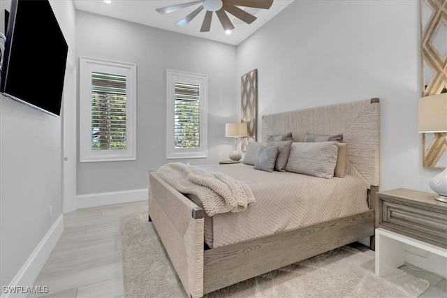 bedroom with light hardwood / wood-style floors and ceiling fan