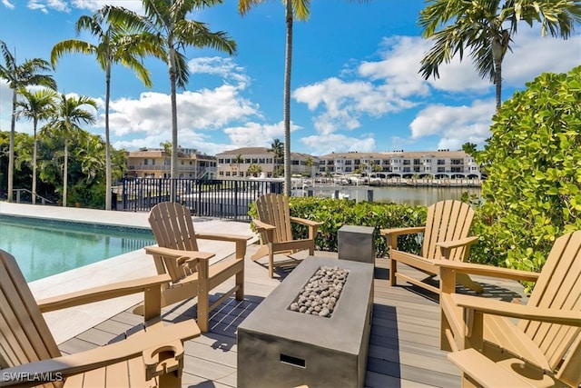 view of pool featuring a deck with water view