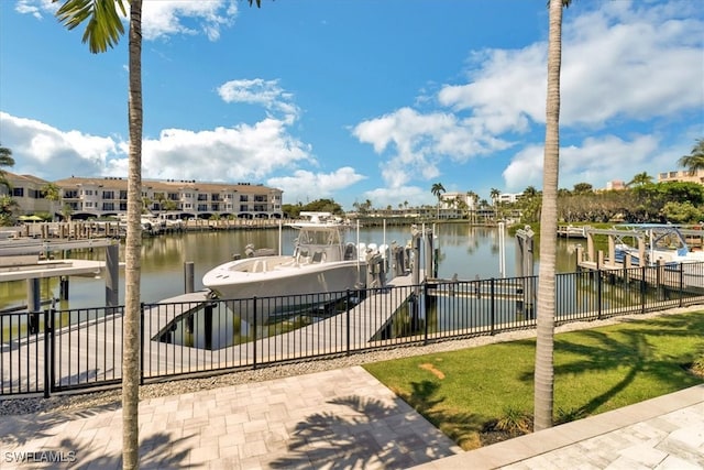 view of dock featuring a water view and a yard