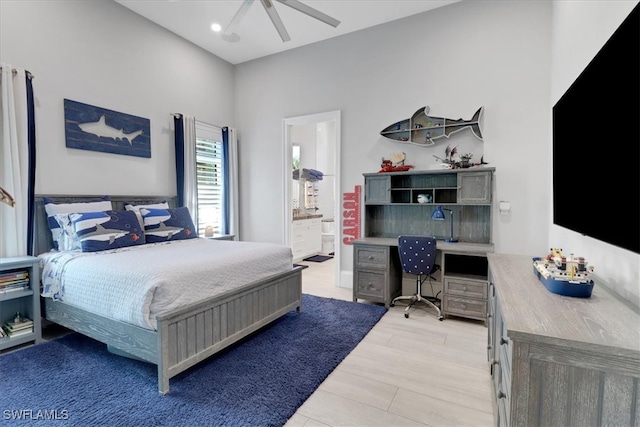 bedroom with connected bathroom, light hardwood / wood-style flooring, and ceiling fan