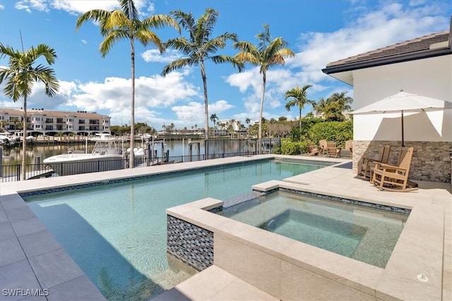 view of pool featuring a water view, an in ground hot tub, and a patio