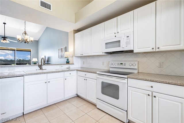 kitchen with white cabinets, white appliances, hanging light fixtures, and a chandelier