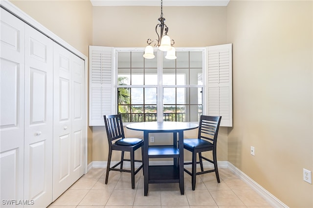 dining room featuring light tile patterned floors and a chandelier