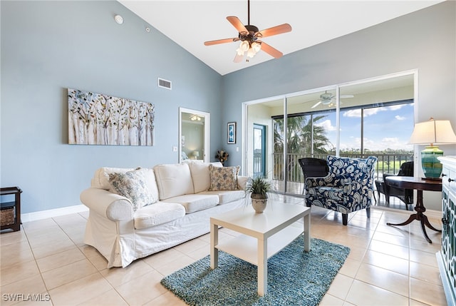 tiled living room with ceiling fan and high vaulted ceiling