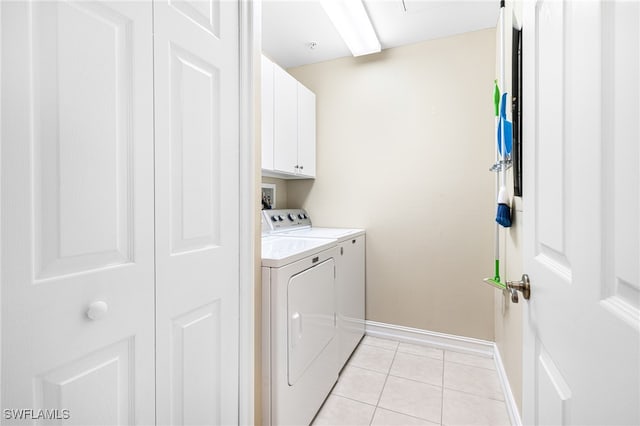 laundry room featuring cabinets, independent washer and dryer, and light tile patterned flooring