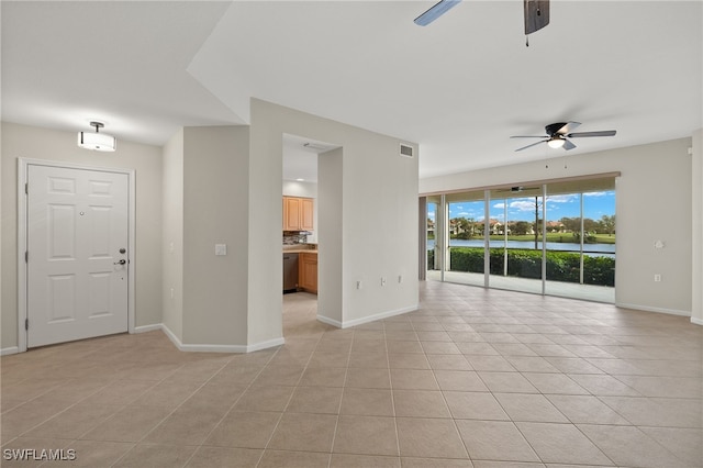 unfurnished room with ceiling fan and light tile patterned floors