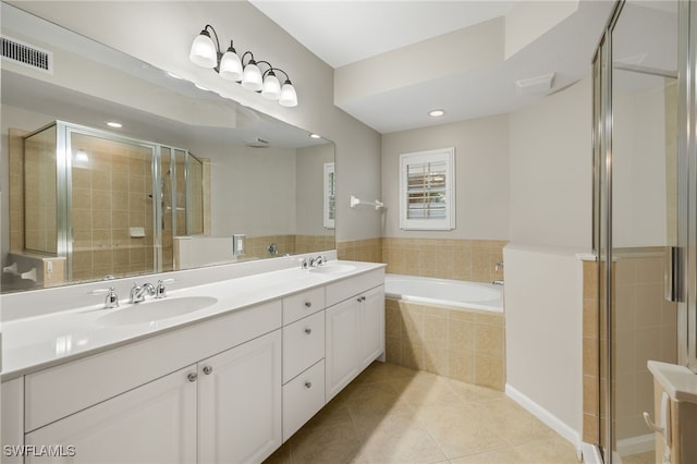 bathroom with shower with separate bathtub, vanity, and tile patterned floors