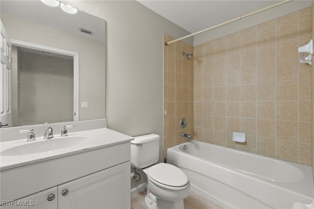 full bathroom featuring vanity, tiled shower / bath combo, tile patterned floors, and toilet