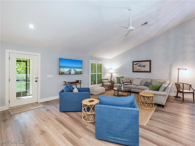 living room with light hardwood / wood-style floors, ceiling fan, and lofted ceiling