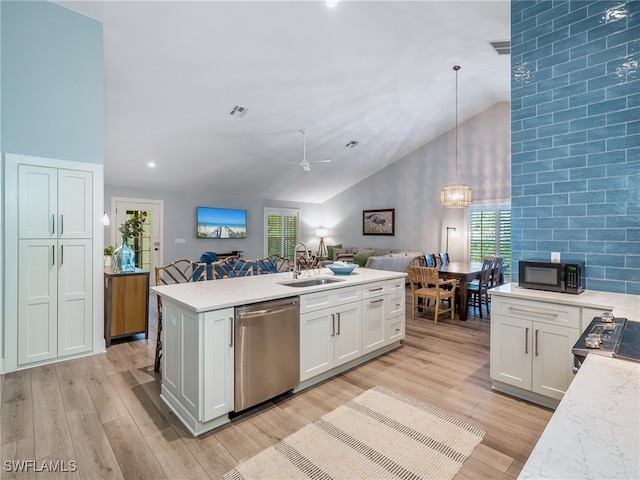 kitchen featuring appliances with stainless steel finishes, white cabinetry, hanging light fixtures, and sink