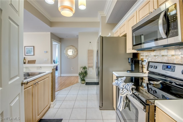 kitchen featuring sink, light brown cabinets, appliances with stainless steel finishes, light tile patterned flooring, and ornamental molding