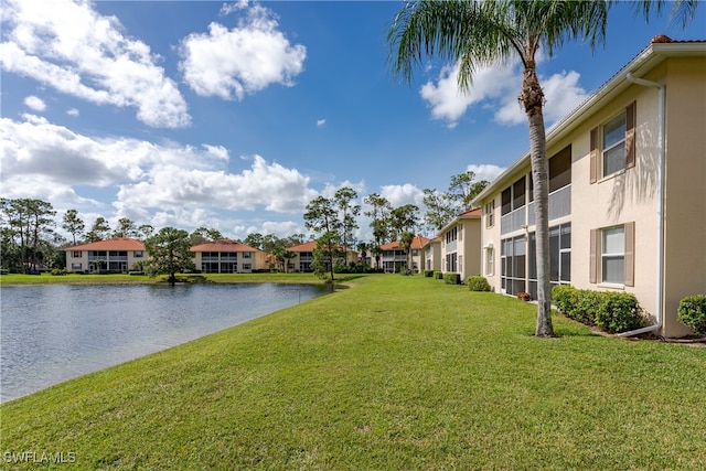 exterior space with a lawn and a water view