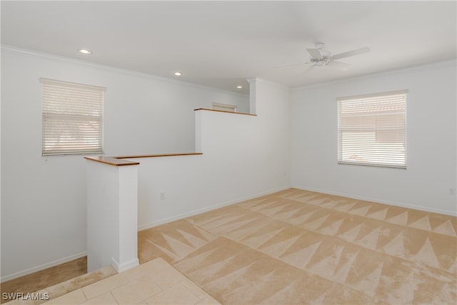 carpeted empty room with ceiling fan and ornamental molding