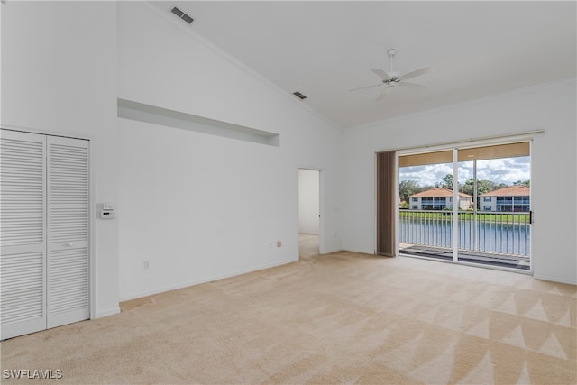 unfurnished room featuring light carpet, a water view, ceiling fan, high vaulted ceiling, and crown molding